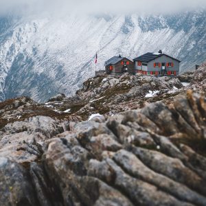 A wide shot of a house isolated on the mountains covered by snow in Capanna Cadlino